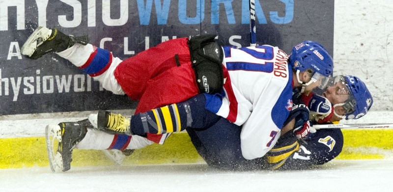 PLAYOFF TAKEDOWN &#8211; Levi Schwab of the Stony Plain Flyers knocks down Braeden Farge of the St. Albert Merchants in the Capital Junior B Hockey League playoffs. The
