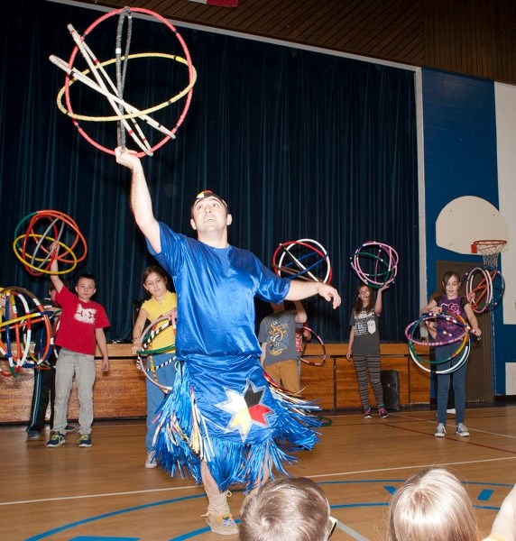 ALL TOGETHER NOW – Hoop dancer Teddy Anderson leads Wild Rose Elementary students through a hoop dance demonstration in the school&#8217;s gym last Friday. All 220-some