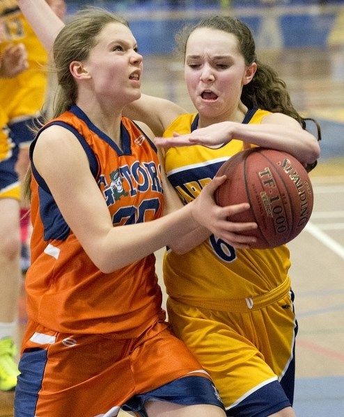 TIGHT CHECKING – Maddy Bartlett of the ESSMY Leopards keeps close tabs on Kaitlyn Kluttig of the Lorne Akins Gators in the SAPEC Tier I city final Wednesday at the SkyDome.