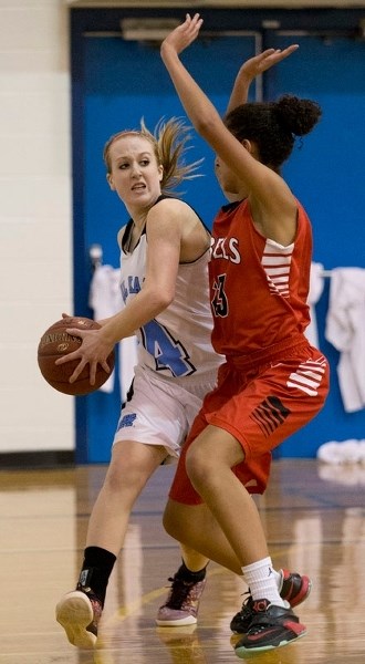 EYEING UP A PASS – Sydney Hurlburt of the Paul Kane Blues looks to distribute the ball in Tuesday&#8217;s playoff against the Jasper Place Rebels to determine the third and