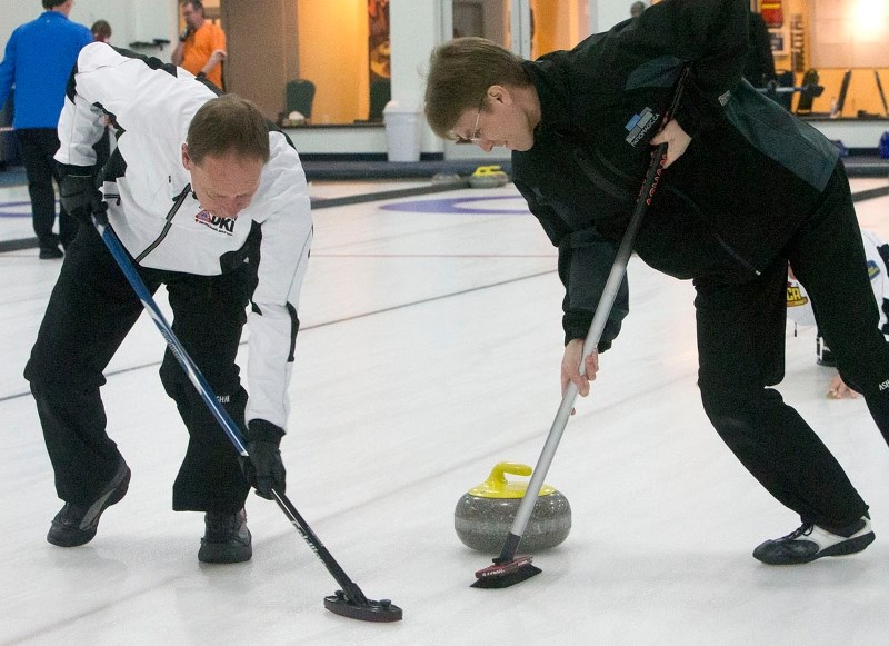 POLISHING THE ICE – Colin Jenkyns sweeps the rock as Mike Howes leans into his broom for the Doug McLennan rink in the President&#8217;s Cup men&#8217;s playoffs Wednesday at 