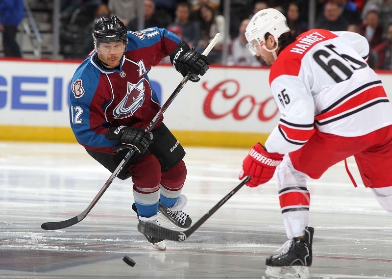 PRIDE OF ST. ALBERT – Jarome Iginla of the Colorado Avalanche pressures Ron Hainsey of the Carolina Hurricanes during a Nov. 22 game at the Pepsi Center in Denver. Thursday