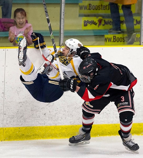 TRIPPED UP – Tristen Gavin of the St. Albert Crusaders is upended by Luke Bellerose of the Peace River Royals in game four in the best-of-five Fountain Tire Cup final