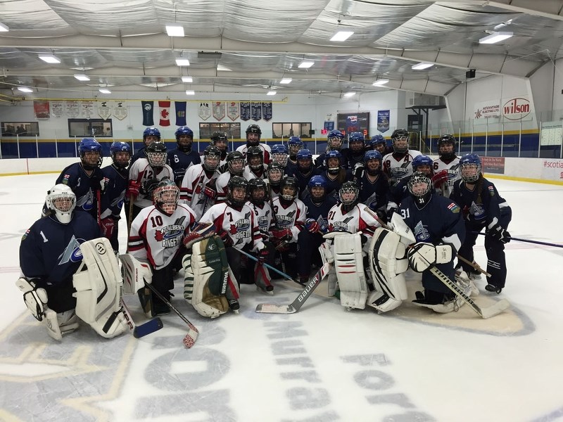 JUNIOR RINGERS – Players from the St. Albert Mission and Calgary Hype junior U16AA teams gather for a group picture after their quarter-final playoff at the Tim Hortons