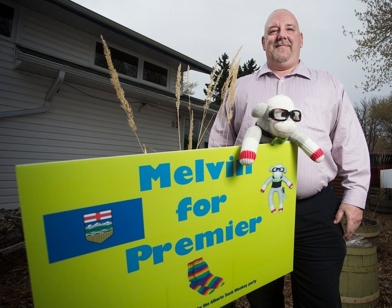 MELVIN FOR PREMIER – Kevin Malinowski poses for a photo with Melvin the sock monkey at his home on Tuesday afternoon. Kevin created this spoof campaign in light of the
