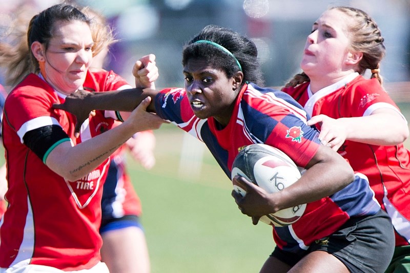 ATTACKER – Marcia Davis of the St. Albert Rugby Football Club battles her way past a pair of Strathcona Druids in Saturday&#8217;s Edmonton Rugby Union spring league match.