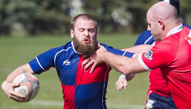 CHOKEHOLD – Antony Fitch of the St. Albert Rugby Football Club is grabbed around the throat in Saturday&#8217;s premier men&#8217;s match against the Strathcona Druids. Fitch 