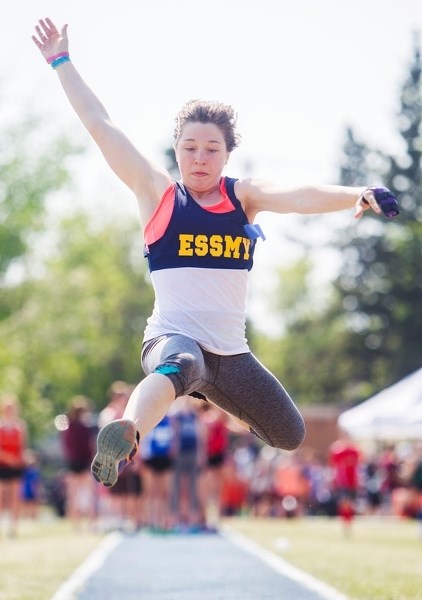 DISTRICT MEET – Madeleine Lovsin of the ESSMY Lepoards goes airborne in the long jump while Moe Tarrabain of the Lorne Akins Gators sends the discus flying during action at