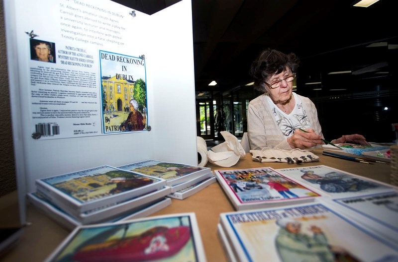 Novelist Patricia Trudeau with her newest title in the Agnes Carroll series