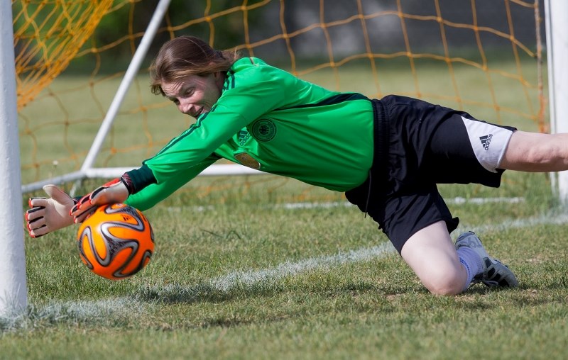 TOO CLOSE TO CALL – Sue Forest-Trainer of Mavericks 09 makes a diving stab at the ball that appeared to have crossed the line on a shot by Suzanne Douziech of the Morinville