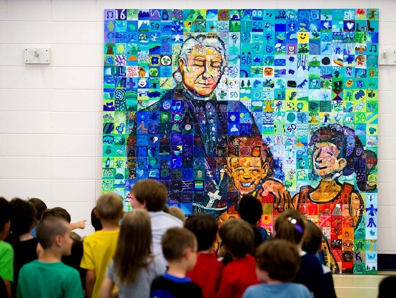 COLLECTIVE ART &#8211; Albert Lacombe students admire their new mural at a assembly on Thursday afternoon. The mural is a collaboration of painted art from students