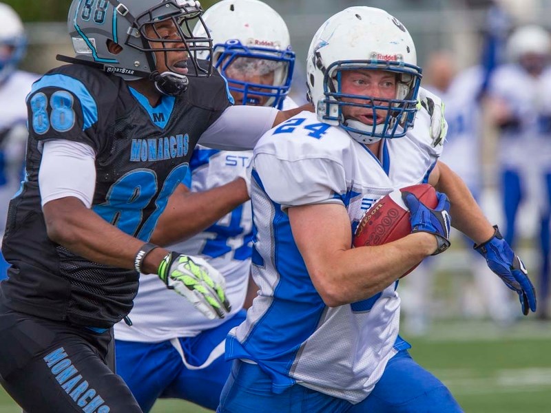 FEELING THE HEAT – Erik Kyler of the St. Albert Stars is pressured from behind in Saturday&#8217;s 60-7 loss to the Fort McMurray Monarchs in the Alberta Football League. The 