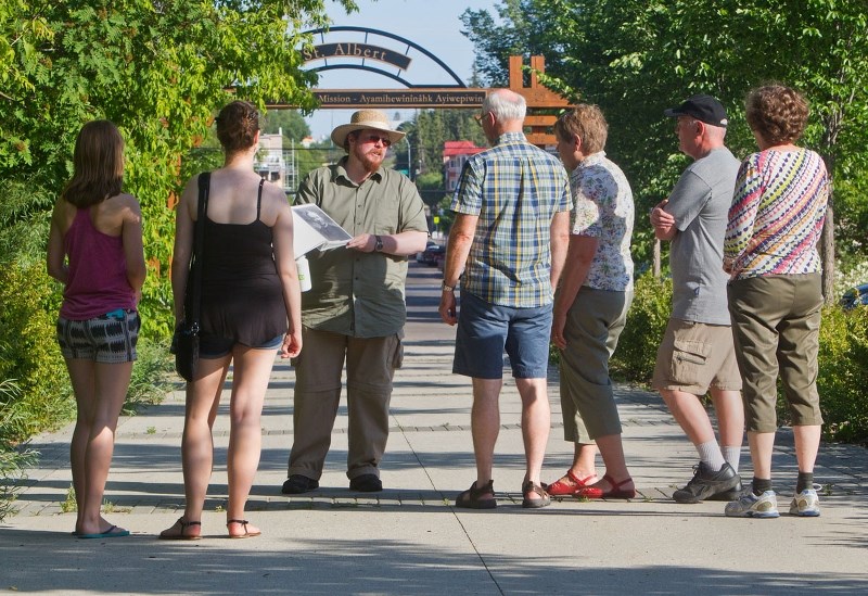 Heritage Sites educational programmer Roy Toomey takes a tour group into the past on Thursday evening as part of his summer series of historical walking tours.