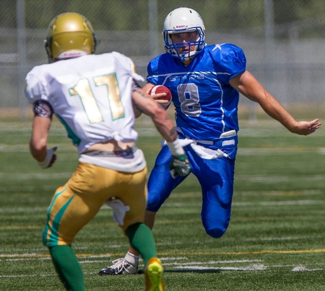 St. Albert Stars quarterback Troy Pappas looks to evade a Calgary Irish attacker during first quarter action at Riel Recreation Park on Saturday afternoon.