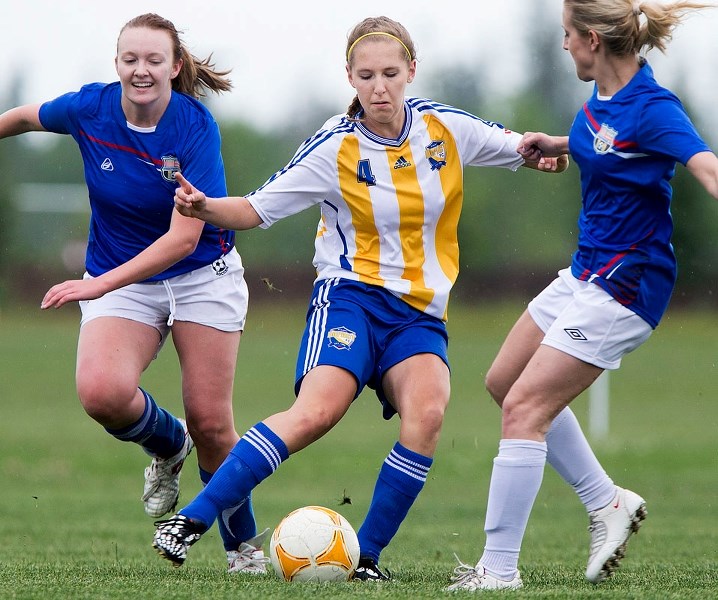 LOCKED IN – Ashley Ponich of the St. Albert Impact Womens 3A team gets caught between two opponents