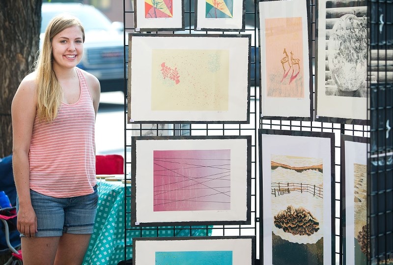 Heather Simonsmeier sets up her booth as she prepares for her second time at the Whyte Avenue Art Walk. The event continues today and tomorrow from 10 a.m. to 5 p.m.