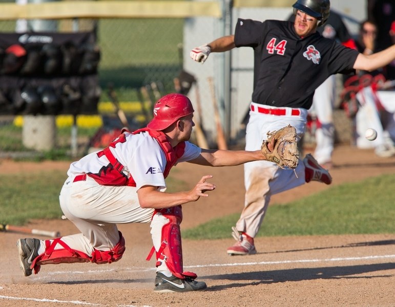 Junior Cardinals (Sr. AA) catcher Scott Peterson prepares to tag an in-coming runner during North Central Alberta Baseball League (NCABL) action against the Camrose Axemen at 
