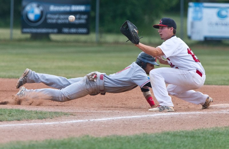 Jake Fischer of the St. Albert Midget AAA Cardinals waits for an incoming ball to first base during a game against the SEEBA Cardinals at Memorial Field on Wednesday evening.