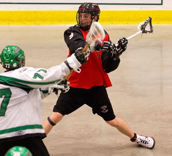 SHOOTING TO SCORE – Derek Burak of the St. Albert Miners is pressured by Steve Morris of the Calgary Raiders in Sunday&#8217;s senior B playoff match in the Rocky Mountain