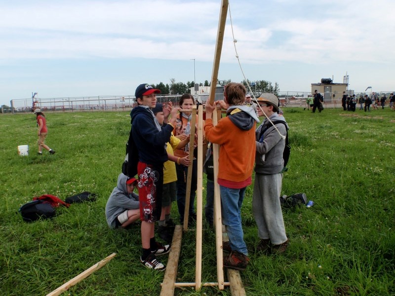 WORKING TOGETHER – Members of the 12th St. Albert Scout group put together a trebuchet at the 2013 Canadian Scout Jamboree in Sylvan Lake