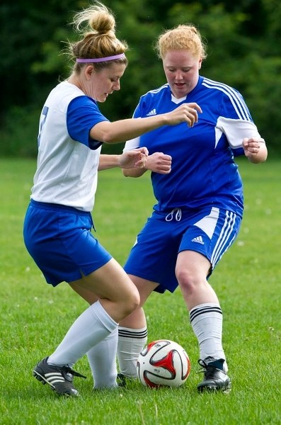 FOOT-BALL – Heidi Voogd (left) of Mavericks 09 and Rebecca Redding of the Morinville Ladies play the ball in Sunday&#8217;s division one match in the St. Albert Women&#8217;s 