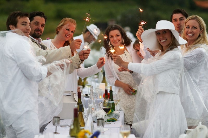 Foodies celebrate a dinner in white event.