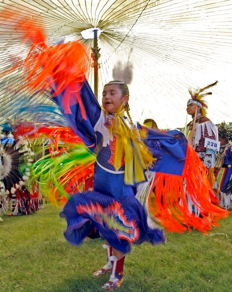 A young dancer participates in the Grand Entry at the Poundmaker Powwow.