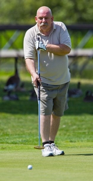 PUTTING OUT &#8211; Rick Sherbo of Edmonton uses a long putter to finish the 17th hole at Sandpiper Golf &amp; Country Club during a recent round.