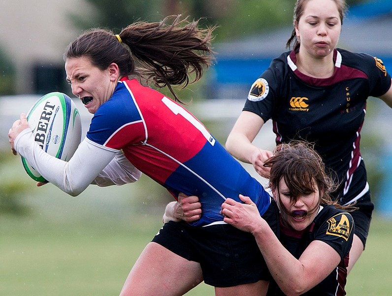 PULLING AWAY – Katelyn Moorhouse of the St. Albert women&#8217;s rugby team battles for yards while tackled by Sydney Bowles of Crude/West. Last year&#8217;s provincial