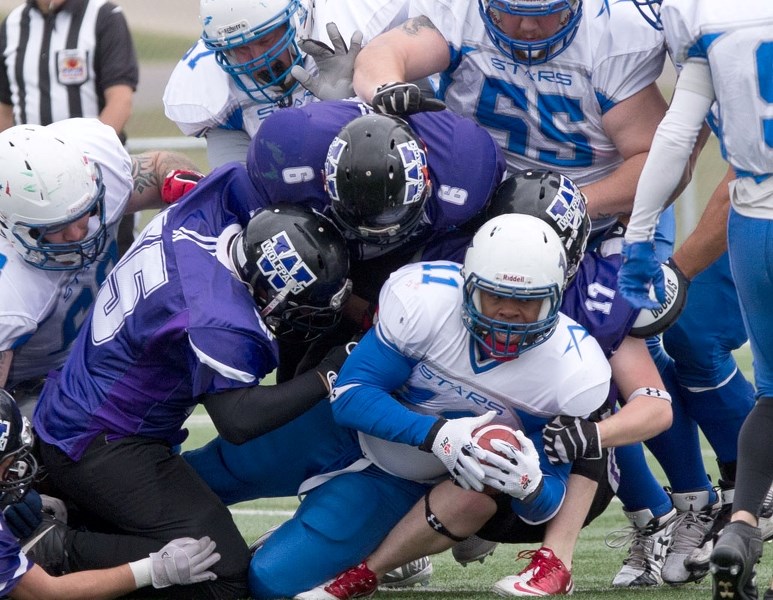 STAR POWER – Craig Carr of the St. Albert Stars draws a crowd in Saturday&#8217;s 56-6 victory over the winless Calgary Wolfpack at Riel Recreation Park in the last Alberta