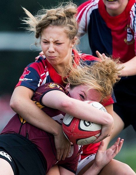 CRASH AND BANG – Ainsley McKinley of St. Albert stops Anna Manchester of the Nor&#8217;Westers Maroon in the Edmonton Rugby Union U19 junior final Wednesday at Ellerslie