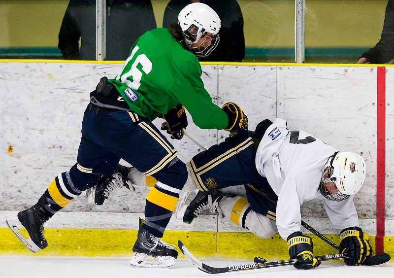 PUCK CHALLENGE &#8211; Cam Lockard (left) battles Eddie Gallagher for possession during the first of two midget AAA St. Albert Raiders&#8217; intersquad games Sunday at