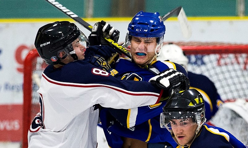 STICK WORK &#8211; Jared Kwasney of the St. Albert Merchants is cross-checked in the neck by Jarred Sorge of the Spruce Grove Regals in Friday&#8217;s junior B exhibition at
