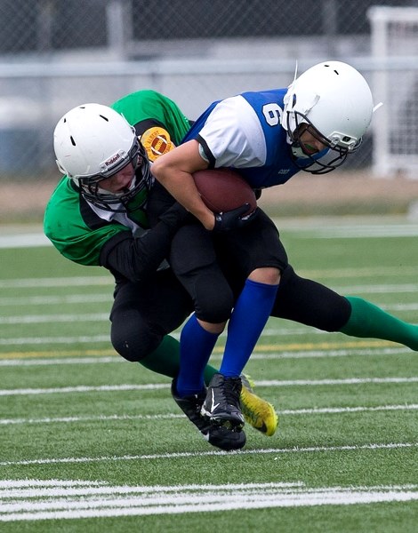 SQUEEZE PLAY – Jace Asay of the St. Albert Colts is lassoed by Aidan Purdon of the St. Albert Riders in Sunday&#8217;s Tier 1/2 peewee season opener in the Capital District