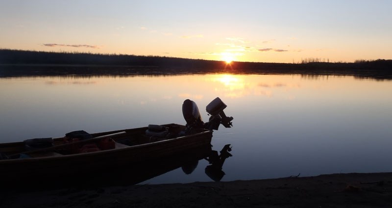 NIGHT FALLS – A shot of the Stinson clan&#8217;s canoe on the shore of the Athabasca River near sunset.