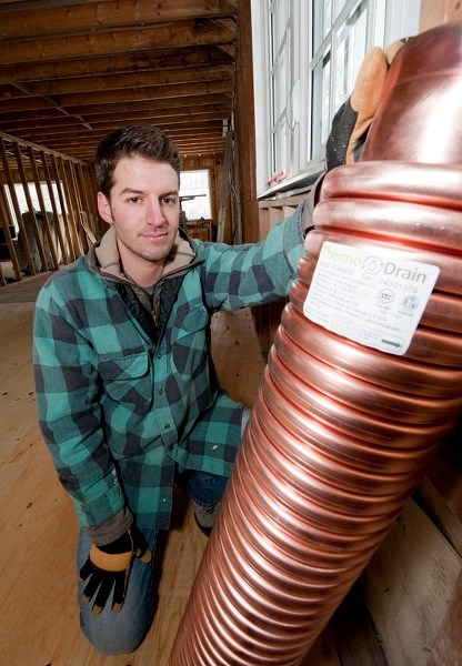 RECOVERING HEAT – Former St. Albert resident Stuart Fix shows off the drain heat recovery device he plans to install as part of his renovation of his new home in Edmonton in