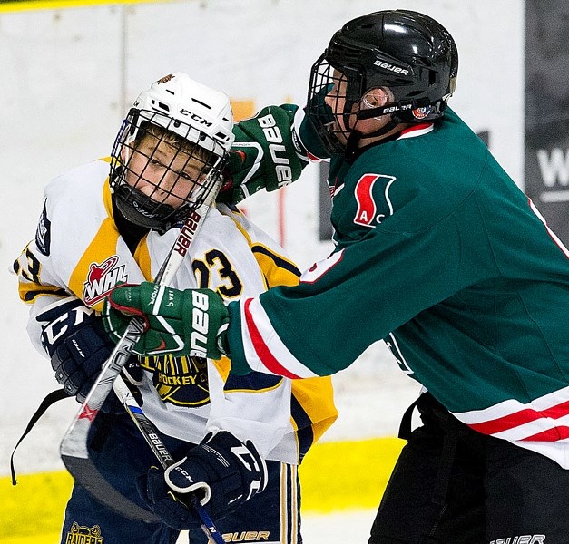 HIGH STICK &#8211; Ethan Edwards of the St. Albert Sabres is on the receiving end of a cross-check in Tuesday&#8217;s home opener against the SSAC Southgate Lions in the