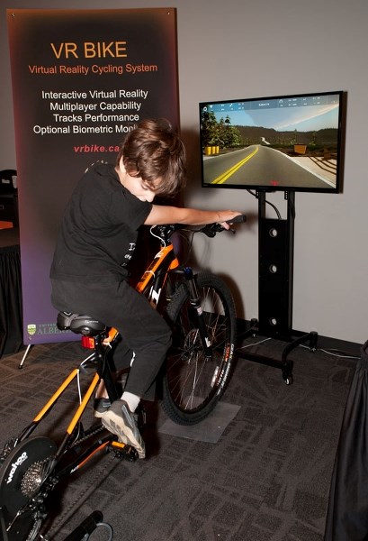 WHERE&#8217;S THE TIRE? – Edmontonian Robert Henderson checks out the U of A&#8217;s VR Bike last Friday at the Telus World of Science in Edmonton. The bike was there as part 
