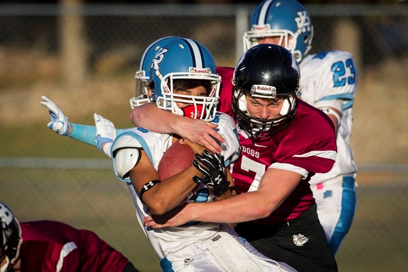 STRANGLEHOLD – Bryce Workman of the Bellerose Bulldogs wraps a high tackle on Cordel Callioux of the Paul Kane Blues in the junior Battle of St. Albert on Tuesday at Riel