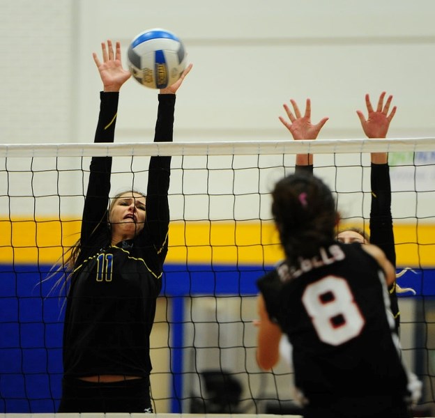REJECTION – Alexis Anderson of the St. Albert Skyhawks blocks the volleyball in Wednesday&#8217;s metro Edmonton division one match against the Jasper Place Rebels (3-1) at