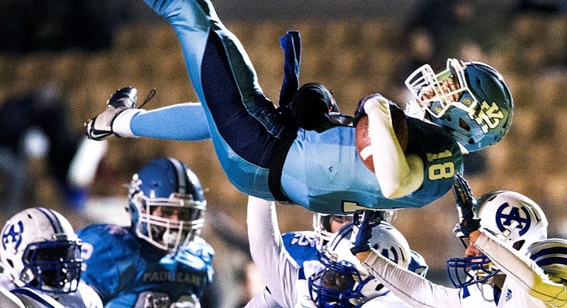 CROWD SURFING – Paul Kane Blues quarterback Brendan Guy soars above the Harry Ainlay Titans on a first and goal play from the three in the first quarter of the Carr division