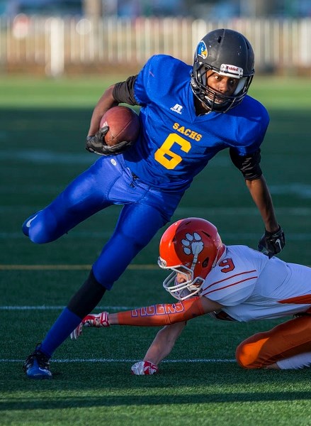 BALANCING ACT – Bryan Breda of the St. Albert Skyhawks keeps his balance while avoiding a tackle by Sam Jones of the McNally Tigers in the Miles division two final Saturday