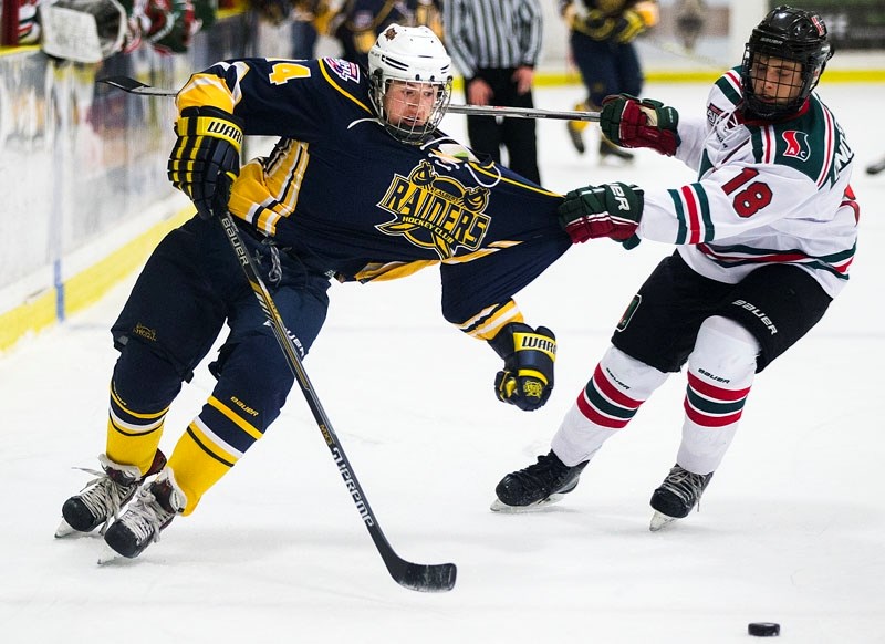JERSEY PULL – Nicholas Onofrychuk of SSAC Bulldogs grabs David Cloutier&#8217;s jersey in Tuesday&#8217;s midget 15 game at Akinsdale Arena. The Bulldogs (9-0-2) doubled the