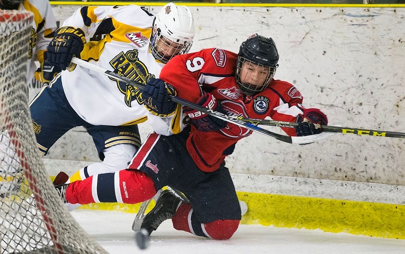 TIGHT CHECKING – Blake Sydlowski of the St. Albert Sabres gets physical with Ethyn Hopp of the Canadian Athletic Club in Tuesday&#8217;s bantam AAA game at Akinsdale Arena.