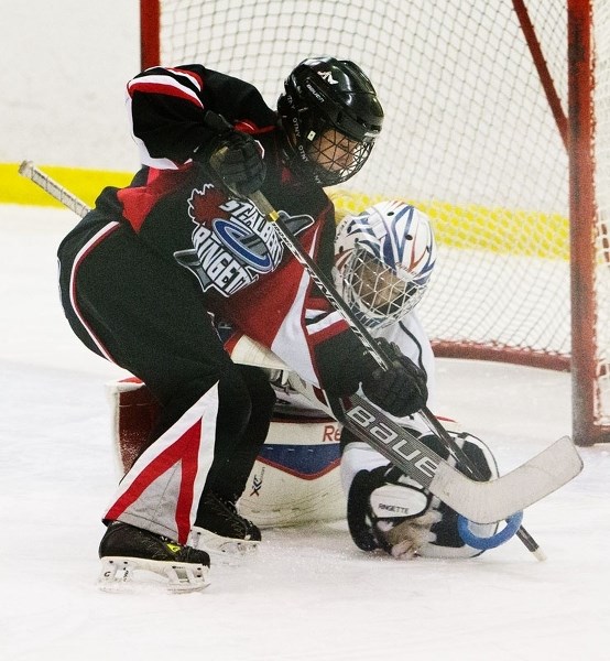 ATTACKING THE NET &#8211; Haley McFaull of the St. Albert Mission U19AA belles controls the ring while pressuring the Lower Mainland (B.C.) Thunder goalie at the 30th annual