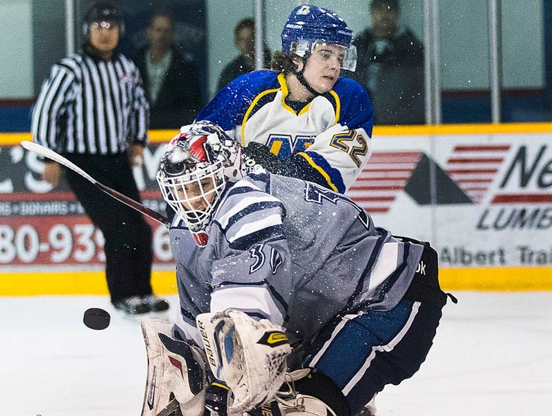 RIVALRY RENEWED – The action was fast and furious around Morinville Jets&#8217; goalie Jordan Greenfield as Matt Havens buzzes the net in Saturday&#8217;s 7-3 victory by the