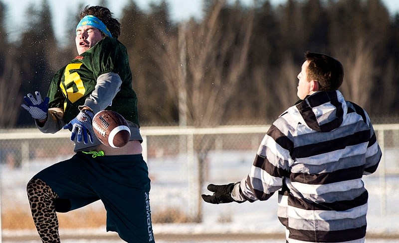 DROPPING THE BALL – Greg Fleming loses his grip on the football with Austen McDonald trailing on the play during the St. Albert Rugby Football Club&#8217;s annual Grey Cup