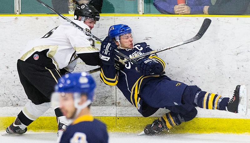BOARDING – St. Albert Merchants captain Dan Rombough is rubbed out against the boards in junior B action at Akinsdale Arena. The Merchants (12-8-2) were 5-6 on home ice