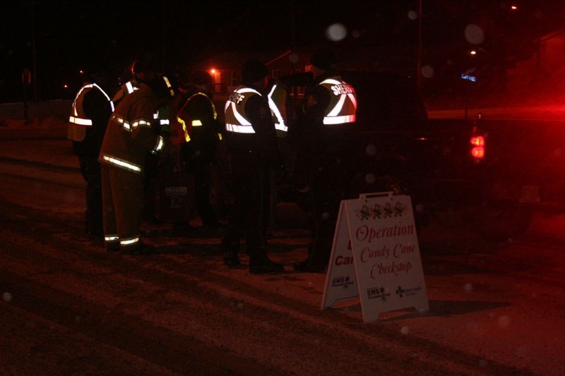 CANDY CANE CHECKSTOP –Emergency services workers teamed up Friday night to spread holiday cheer – and a few cautions – on Alexander First Nation.