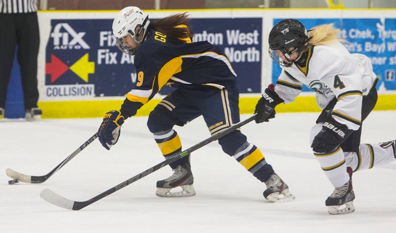 RUSHING THE PUCK – Breanna Golosky of the St. Albert Slash skates away from Bailey Stang of the PAC Saints in the Alberta Major Midget Female Hockey League game on Sunday at